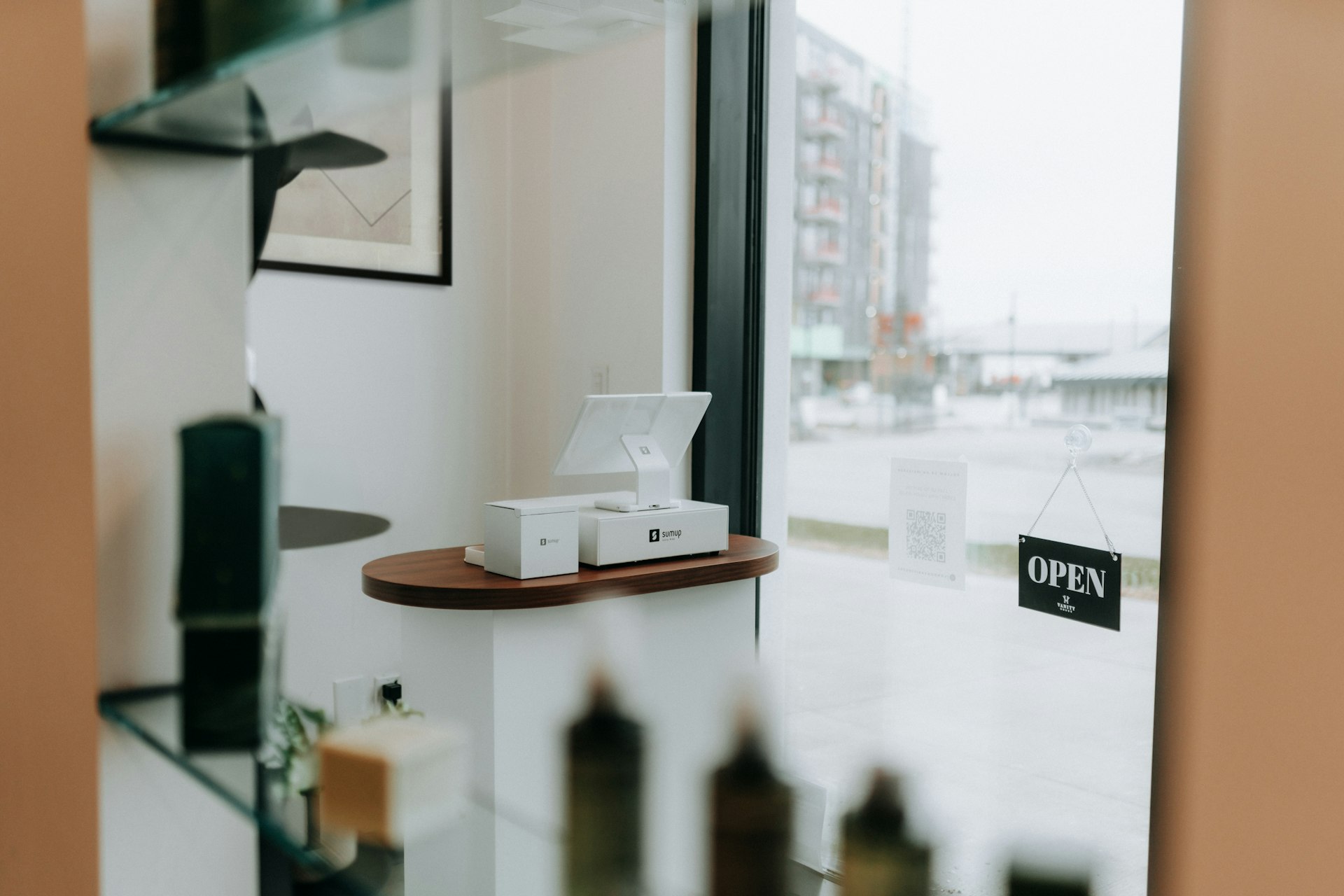 A modern retail display with window and open sign.
